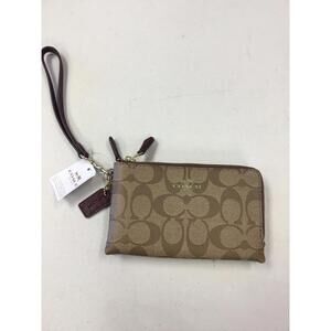 Coach Medium Zip Around Wallet in signature canvas.